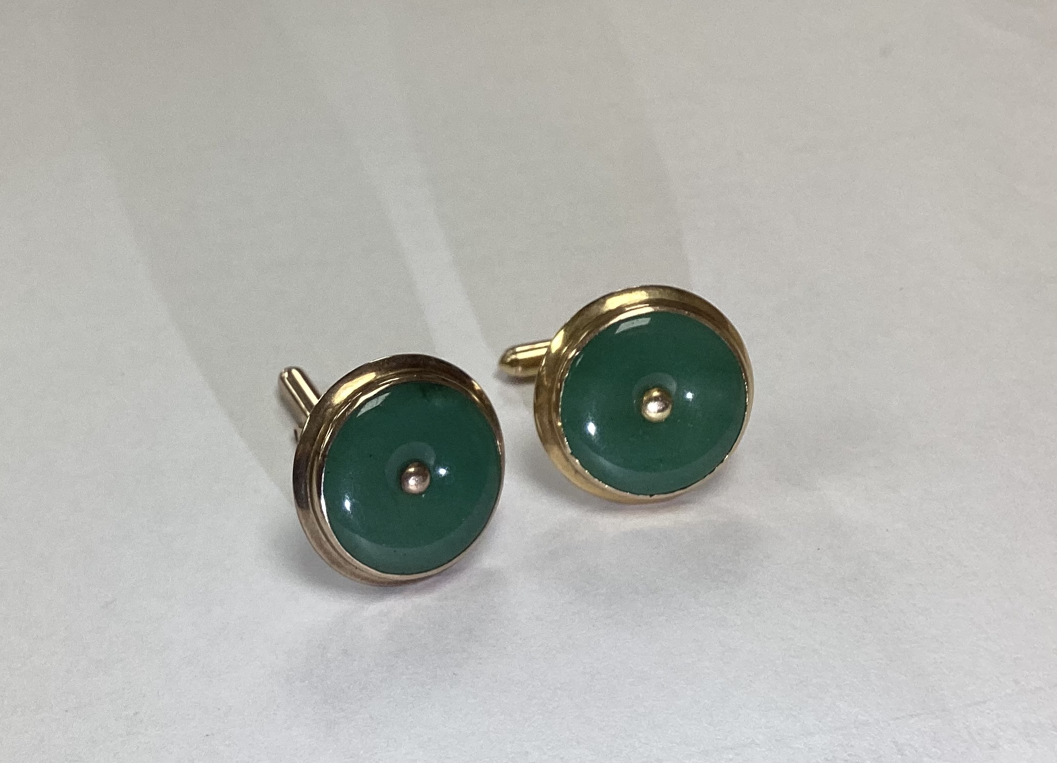 Two pairs of cufflinks, including textured 750 yellow metal 16.5 grams and 9k and jade set disc cufflinks.